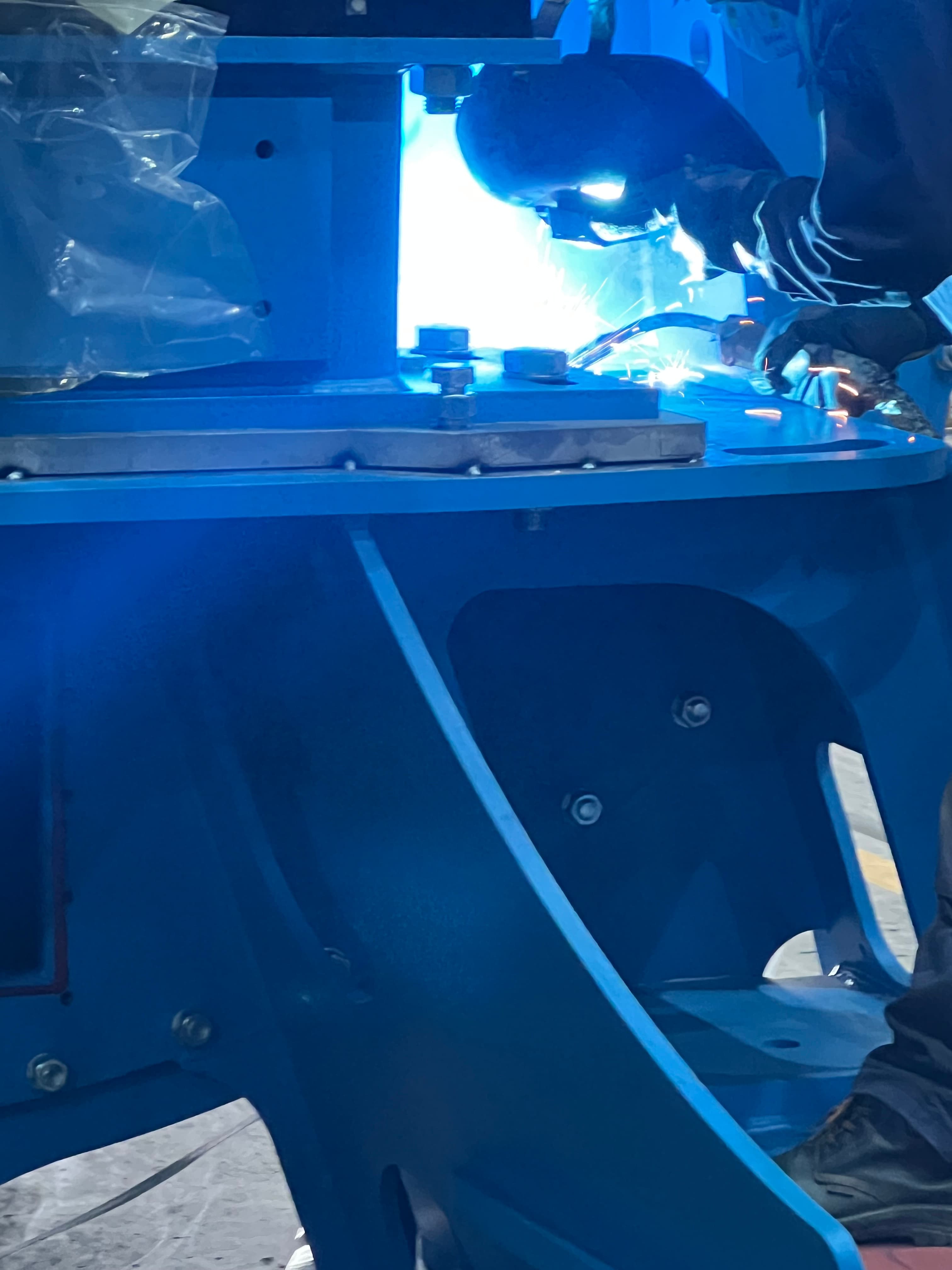 Haarslev technician inspecting equipment with specialist tools